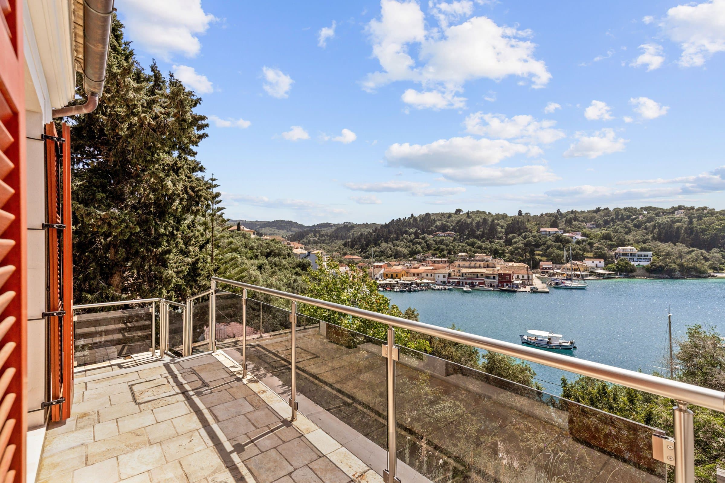 View from the villa terrace railing down over Lakka bay, the harbour and the village